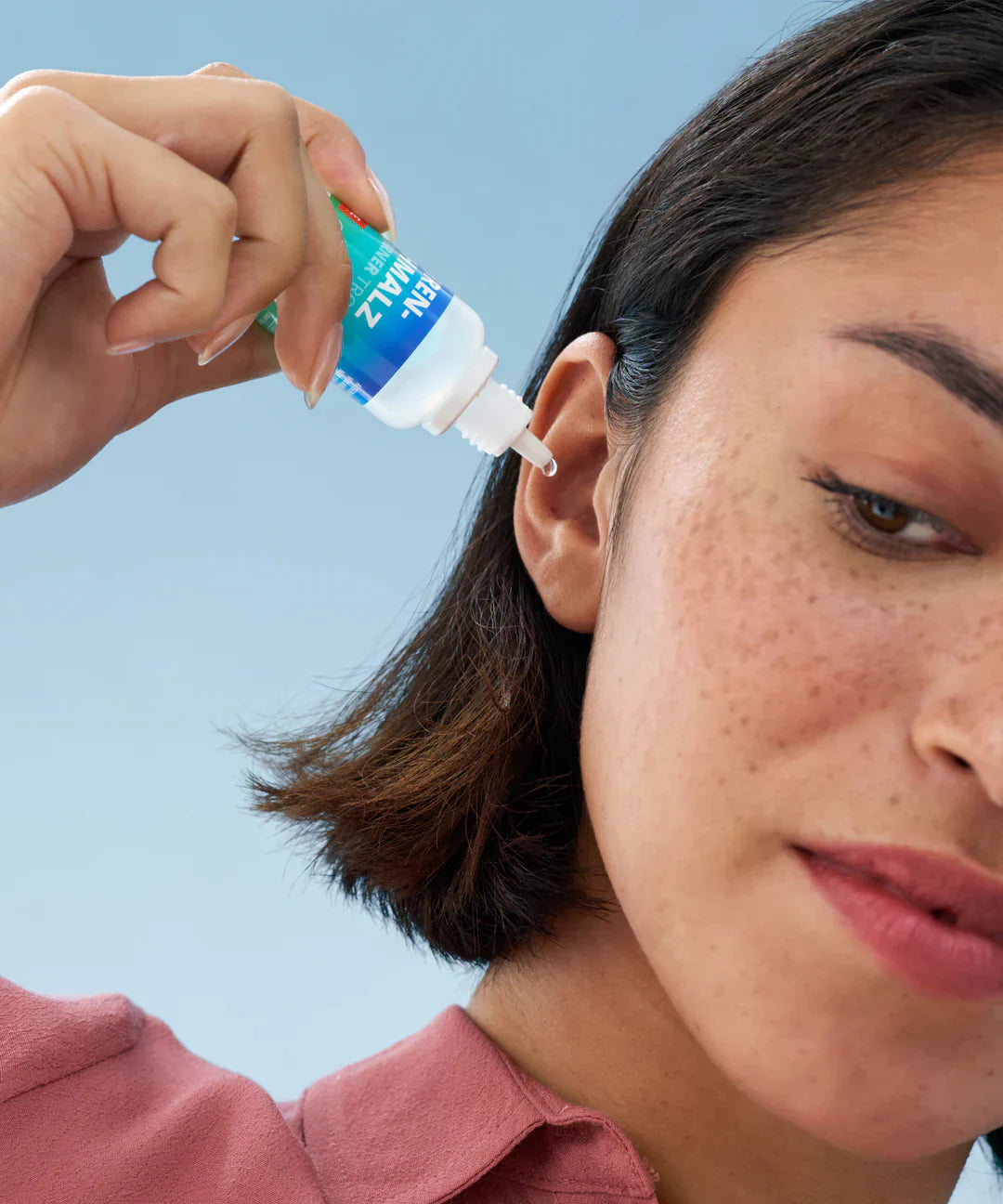 A woman cleaning her ear.