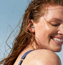 Women wearing Alpine earplugs and smiling