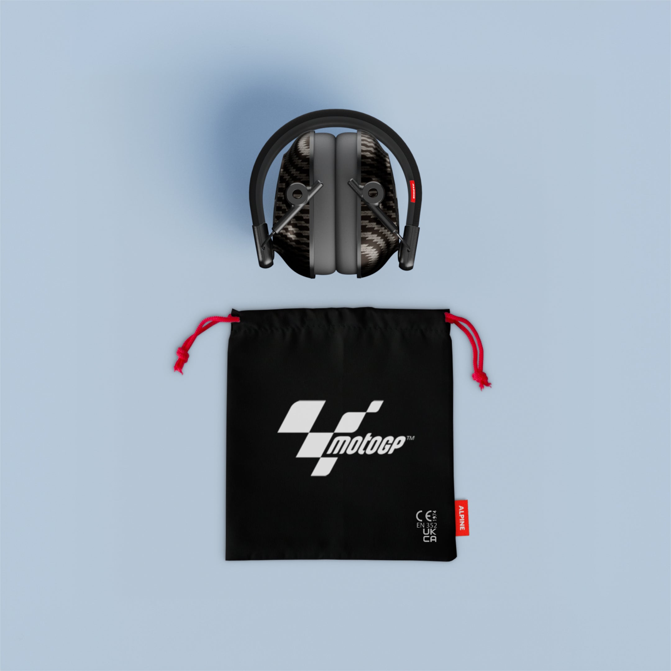 Folded Alpine MotoGP Earmuffs above a black drawstring pouch with red cords and MotoGP logo
