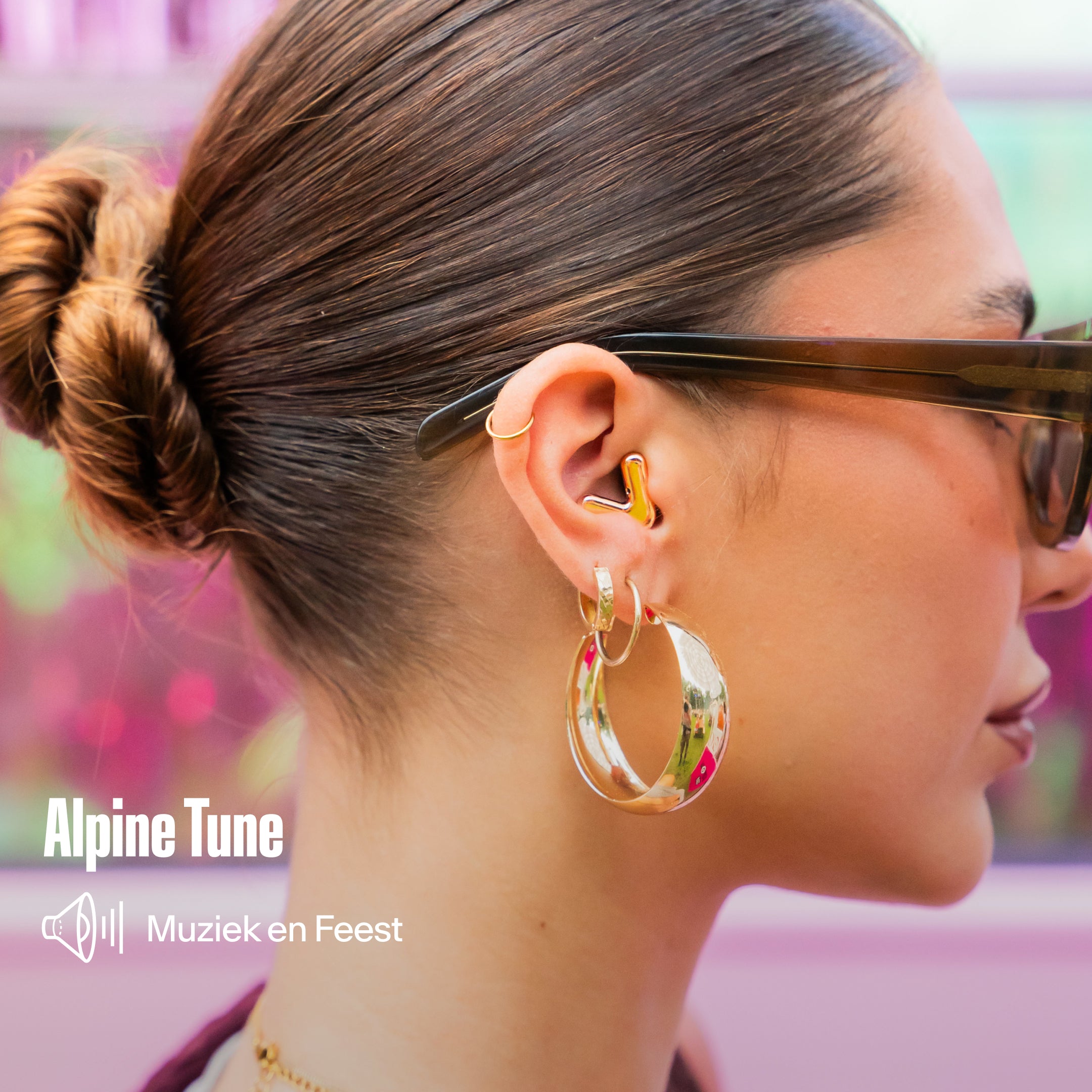Person wearing Alpine Tune earplugs 