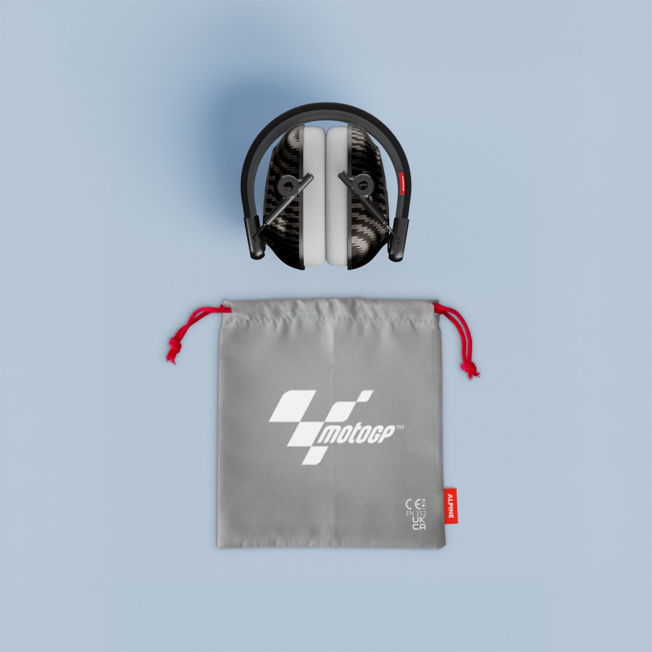 Folded Alpine MotoGP Racing Muffy earmuffs above a grey drawstring pouch with red cords and MotoGP logo 