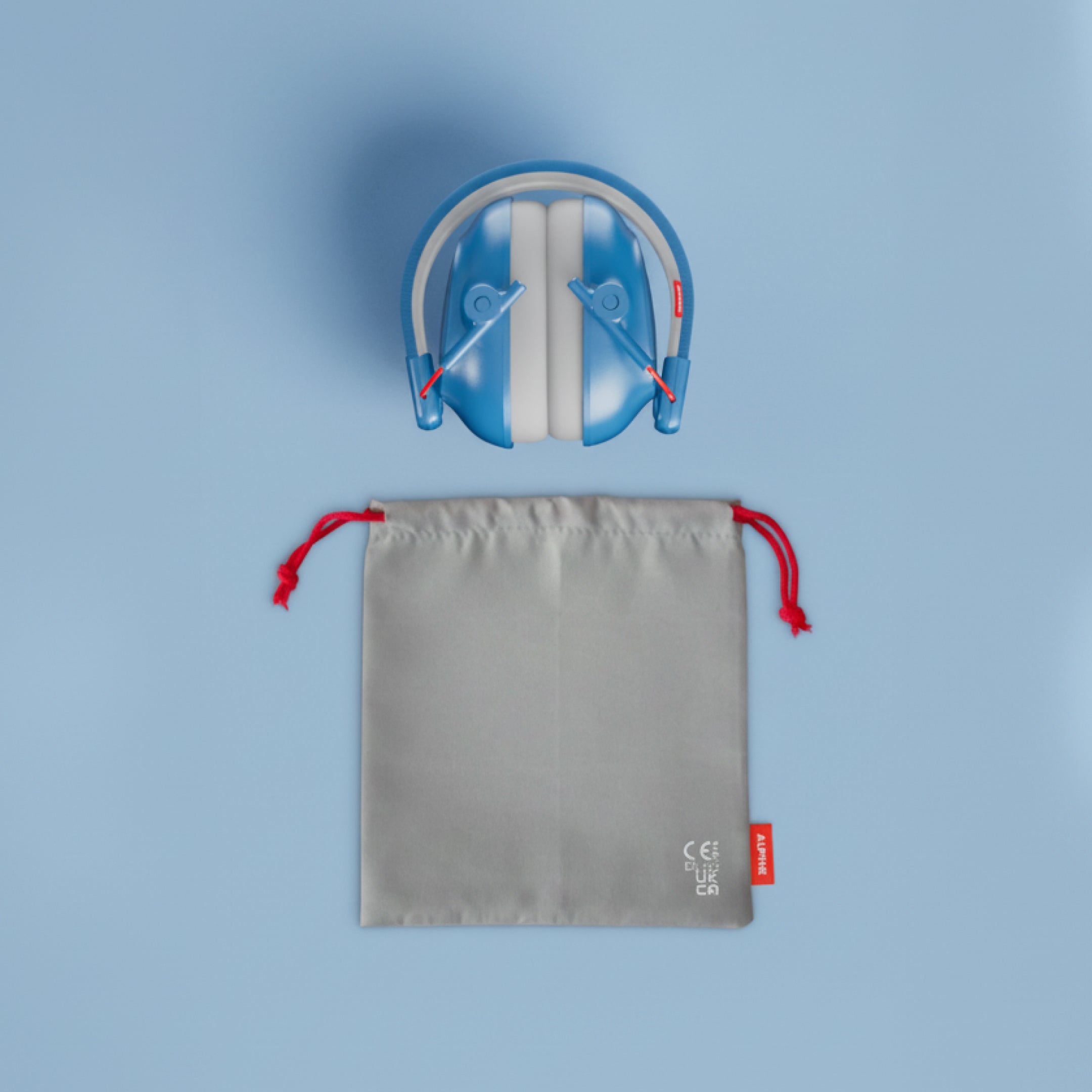 Alpine Muffy Baby ear defenders in blue, folded, with grey carrying pouch 