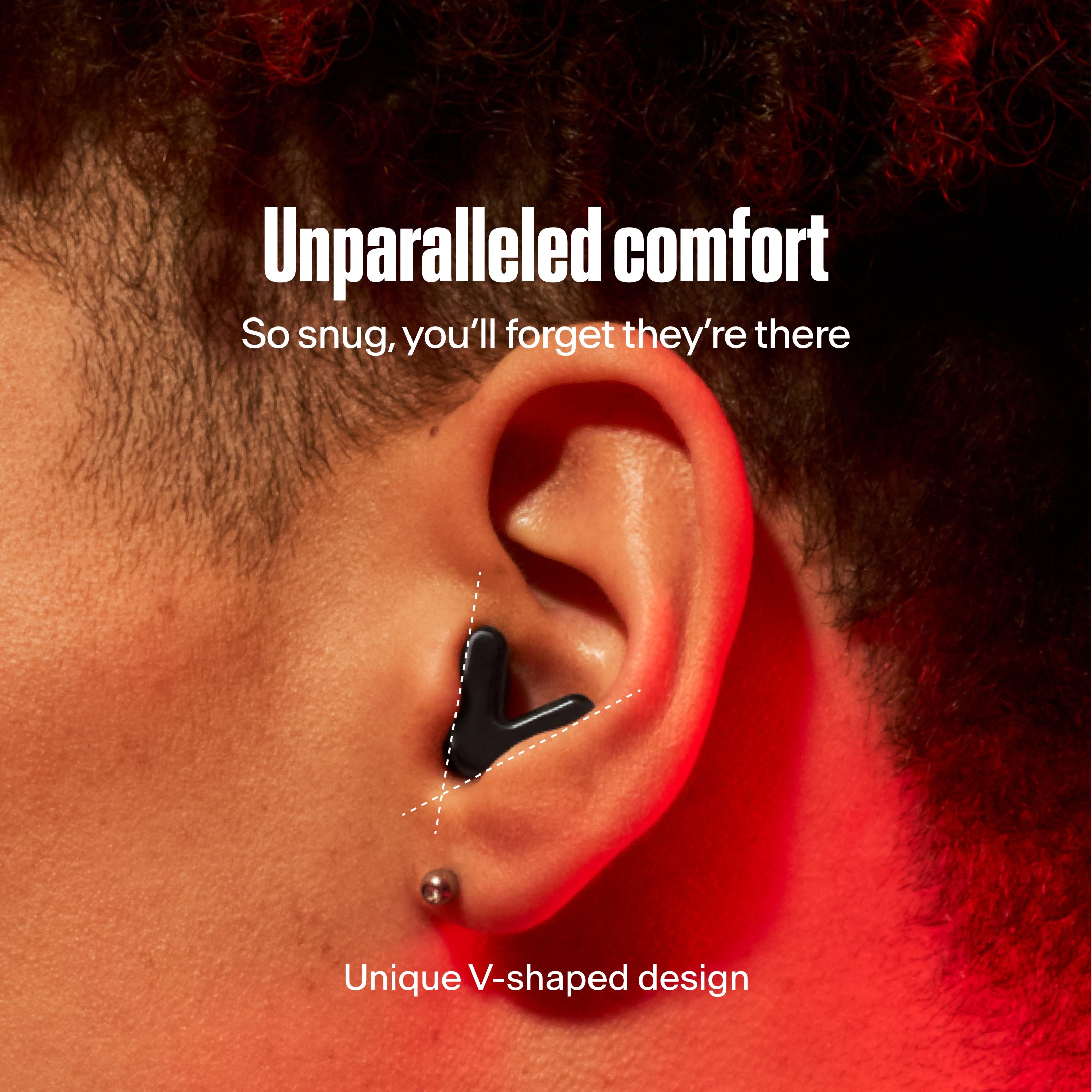 Close-up of an ear with a black Alpine Tune earbud, with the text &
